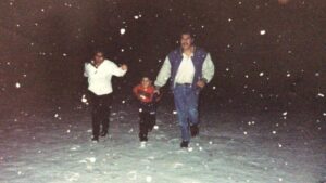 Young Oscar and parents running through the snow